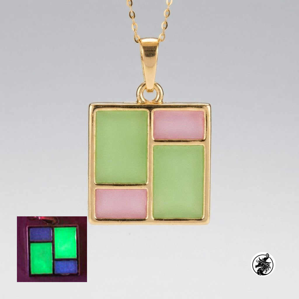 A gold square pendant necklace with a geometric patchwork design featuring light green and pink enamel sections, shown on a gray gradient background with an inset glow-in-the-dark test image in the bottom-left corner.