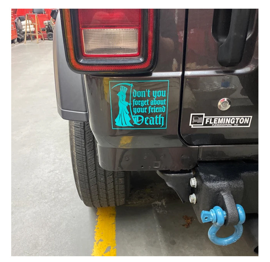 Back of a black vehicle with a 'Don't forget about your friend Death' decal and