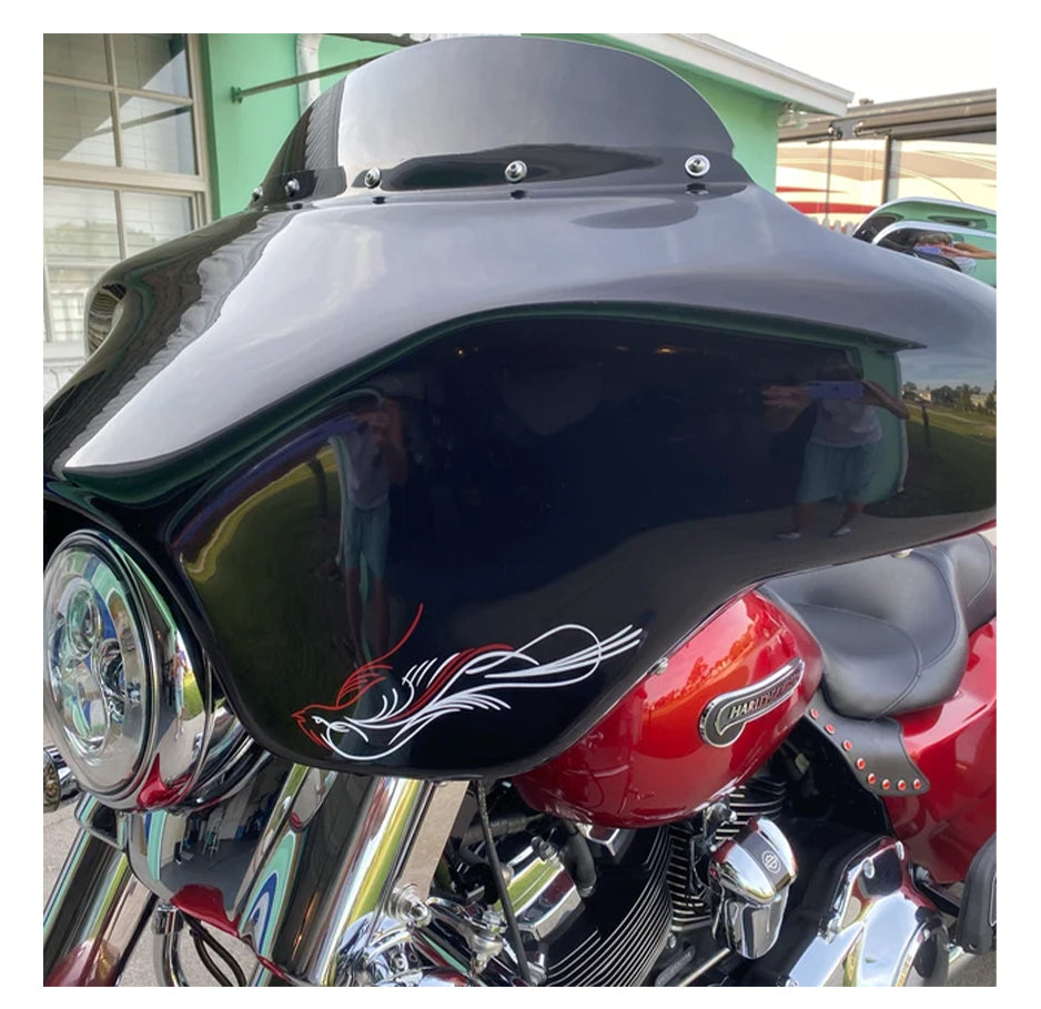 Close-up of a motorcycle with a visible pinstripe, parked indoors.