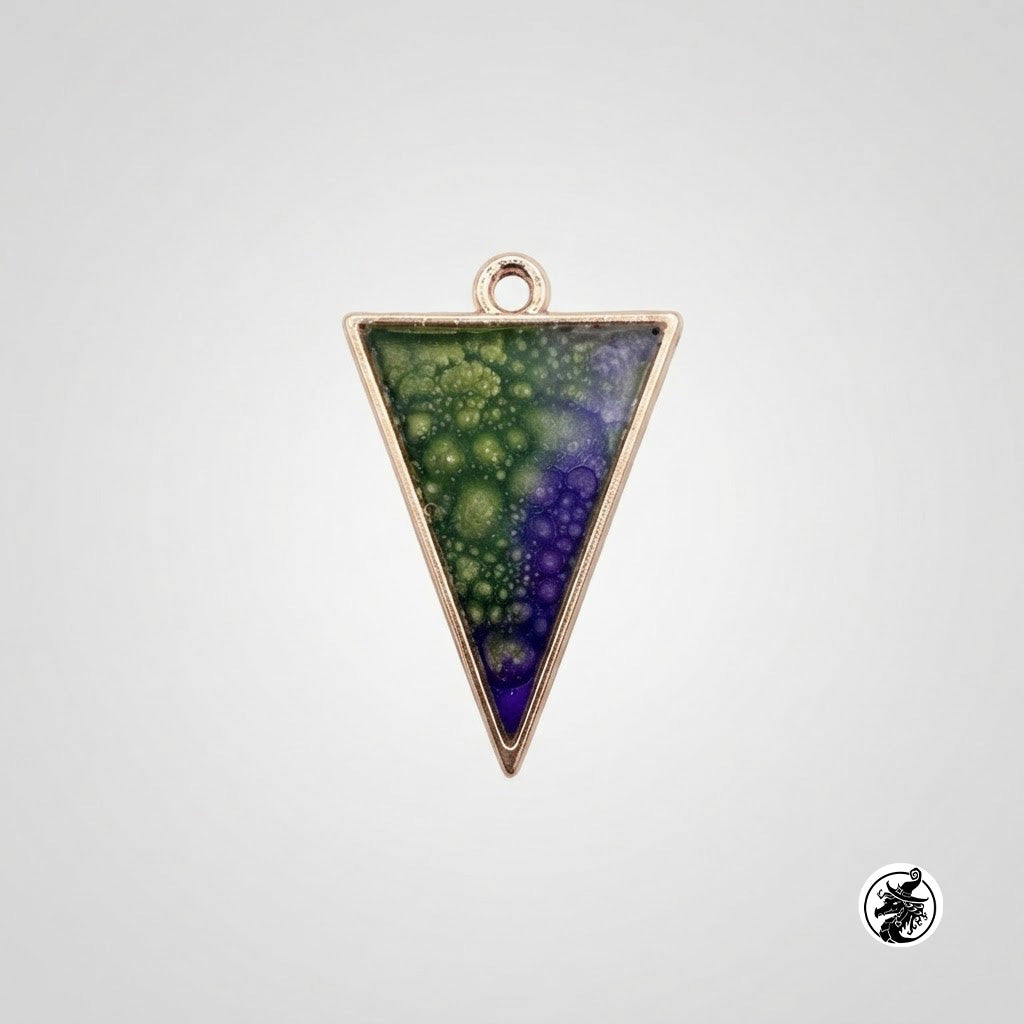 A triangular pendant charm with a rose gold-toned metal border and a top loop, featuring a fractal-like pattern in green and purple. The pendant is centered on a light gray background with a small circular logo in the bottom right corner.