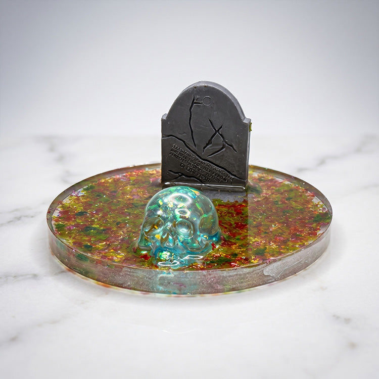 Skull cell phone stand with gold accents and modern design, beauty shot.