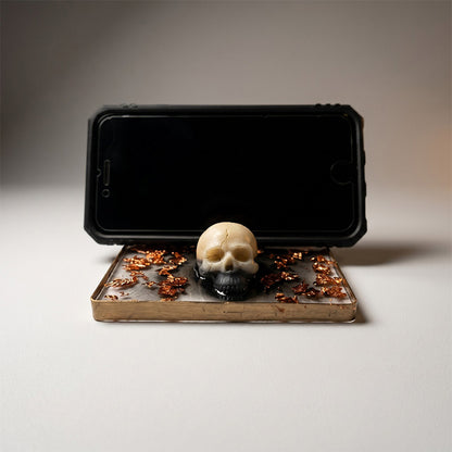 Phone case with a skull design on a stand