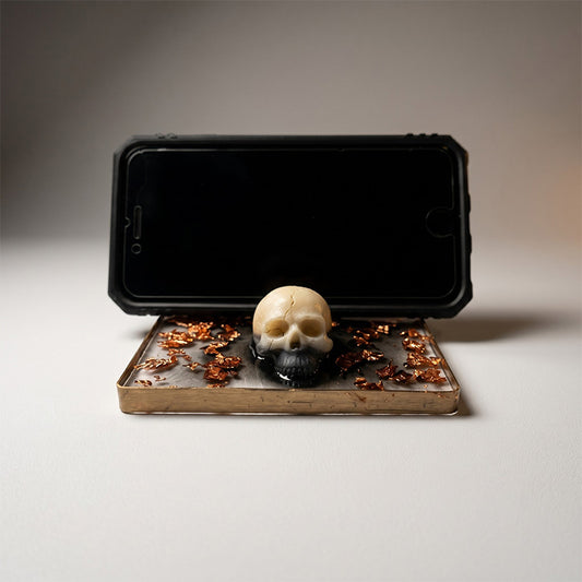 Phone case with a skull design on a stand
