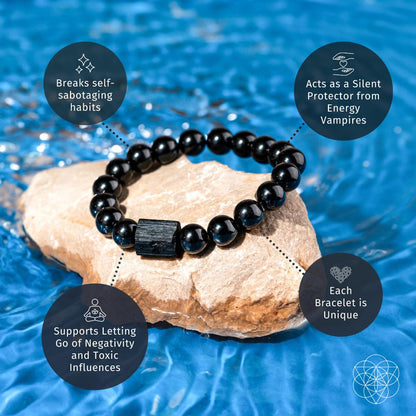 The Habit Breaker - Black Obsidian & Tourmaline Bracelet by Conscious Items rests on a rock in blue water. Text bubbles highlight: breaks habits, offers protection, aids release, and each bracelet is uniquely crafted.