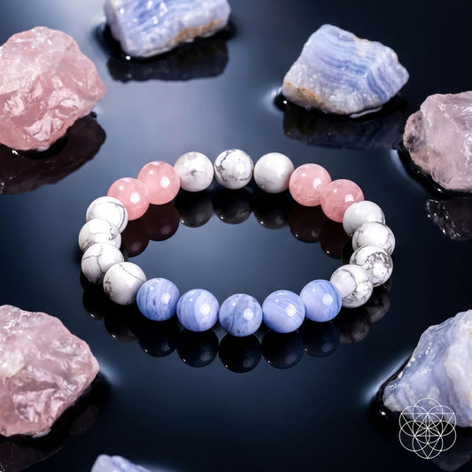 The 3AM Thoughts Off - Deep Sleep Trio Bracelet by Conscious Items, featuring alternating white, pink, and light blue beads for restful sleep, is displayed on a shiny black surface with rough pink and blue crystals; a geometric logo sits at the lower right.