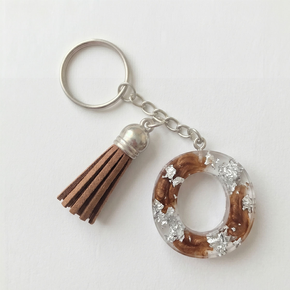 Keychain with a tassel and circular design on a white background