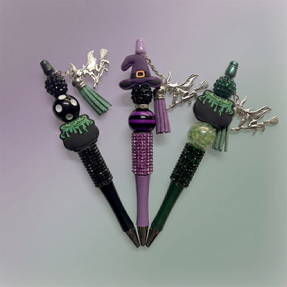 Set of decorative pens with Halloween-themed designs on a gradient background