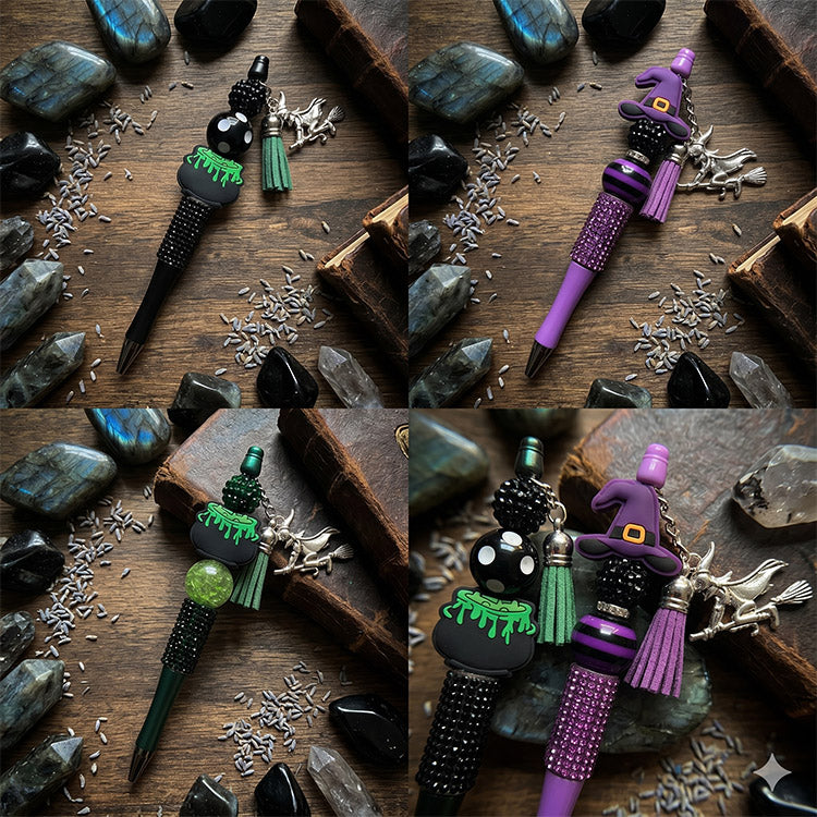 Decorative pens with witch-themed designs on a wooden surface with stones and herbs.